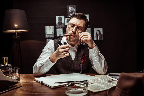 Detective in glasses and white shirt lighting cigar in dark office