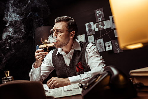 Detective in glasses and white shirt lighting cigar in dark office