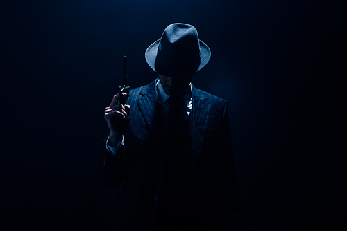 Silhouette of gangster raising gun on dark blue background