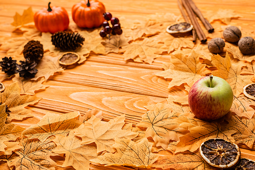 selective focus of autumnal decoration on wooden background