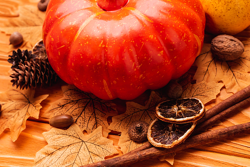 pumpkin with autumnal decoration on wooden background