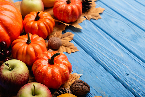 autumnal harvest and foliage on blue wooden background
