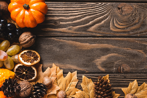 top view of autumnal harvest on brown wooden background