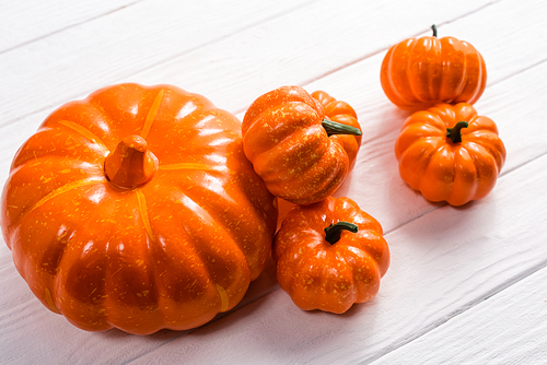 decorative pumpkins on white wooden background