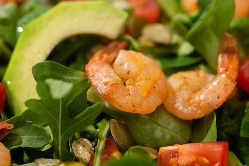 close up view of fresh green salad with shrimps and avocado