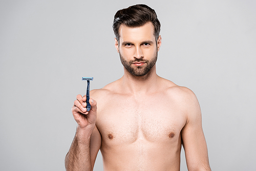 muscular and handsome man holding razor isolated on grey