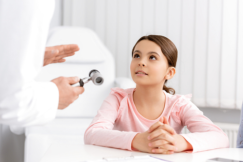 cropped view of ent physician showing otoscope to cute attentive kid