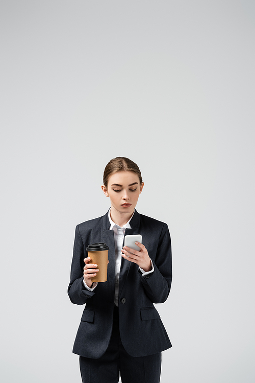 young businesswoman with coffee to go isolated on grey