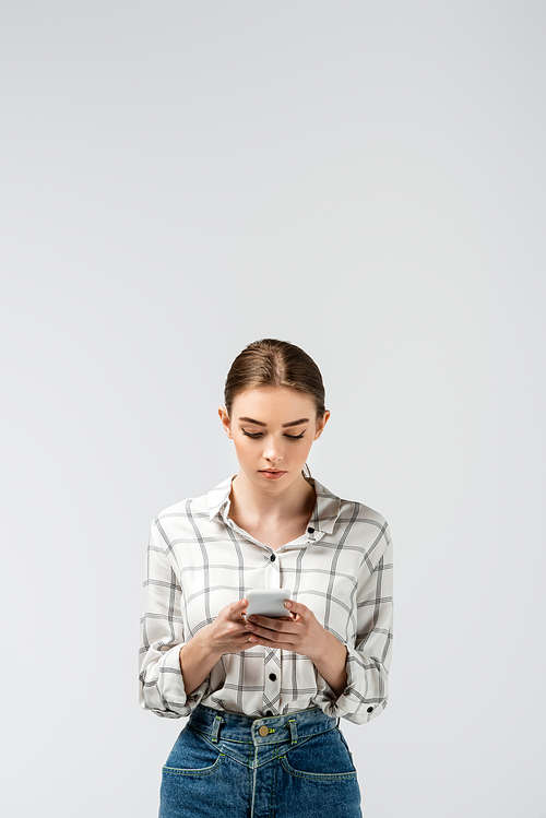 attractive girl using smartphone isolated on grey