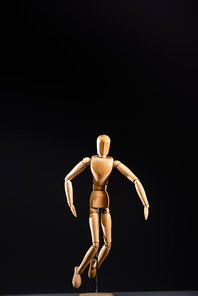 wooden marionette posing isolated on black