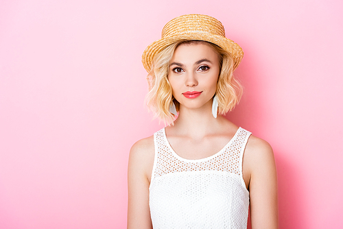 young woman in straw hat  on pink
