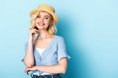 young woman in straw hat  on blue