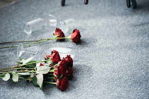 flowers and broken glasses on floor in robbed apartment