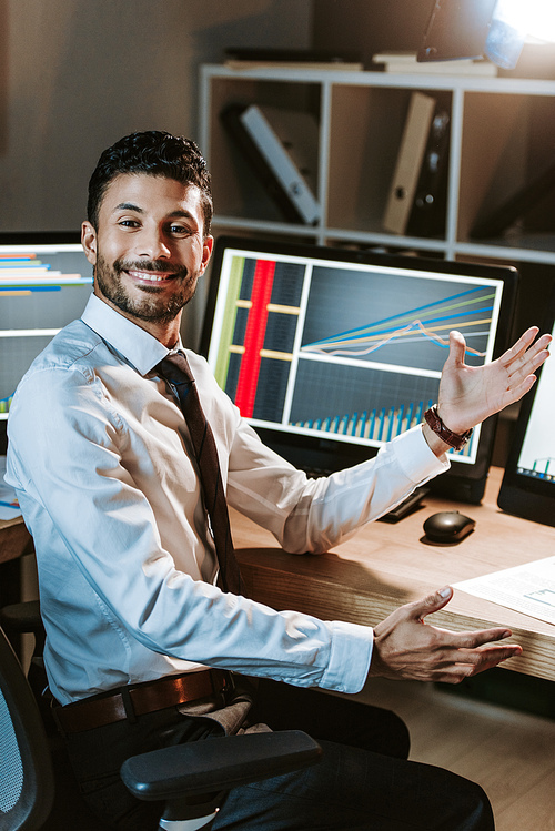 smiling bi-racial trader with outstretched hand 