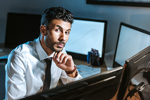 pensive bi-racial trader  in office