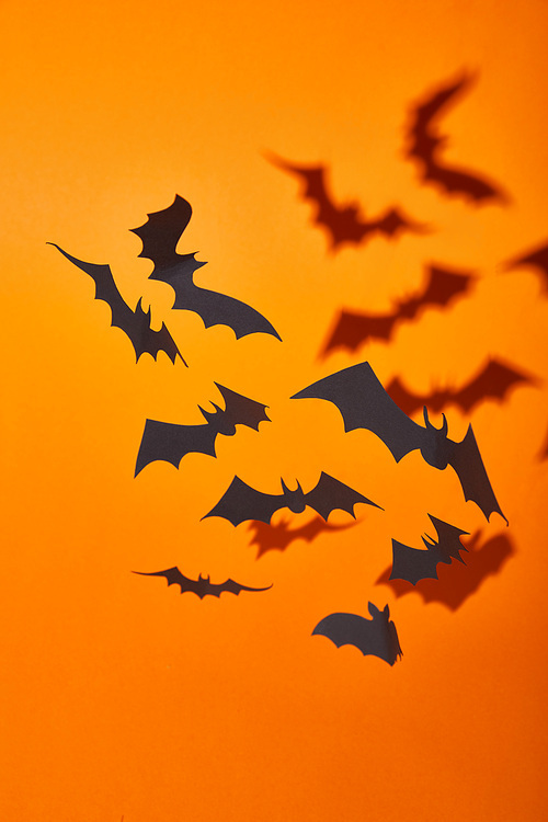 paper bats with shadow on orange background, Halloween decoration