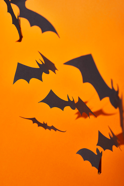 paper bats with shadow on orange background, Halloween decoration