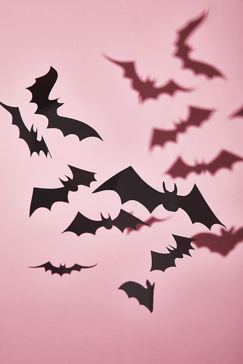 black paper bats with shadow on pink background, Halloween decoration