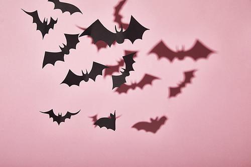 black paper bats with shadow on pink background, Halloween decoration