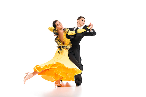 elegant young couple of ballroom dancers dancing on white