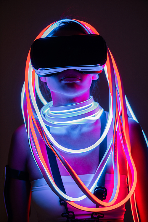 futuristic african american woman in vr headset and neon lighting