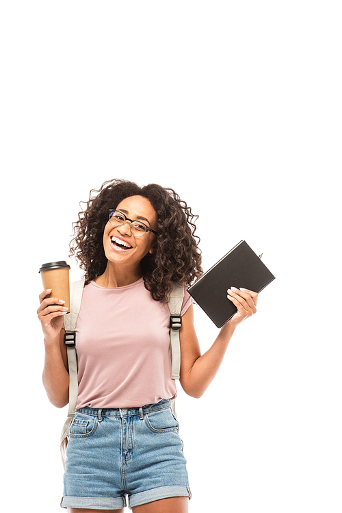 African american student in eyeglasses holding coffee to go and notebook isolated on white