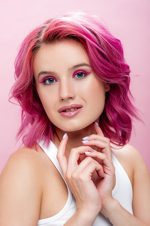 young woman with colorful hair and makeup posing isolated on pink