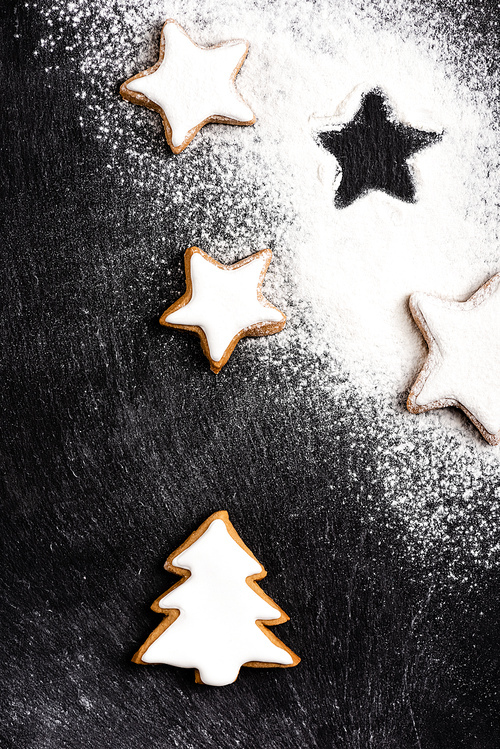 Top view of christmas gingerbread cookies covered with sugar powder