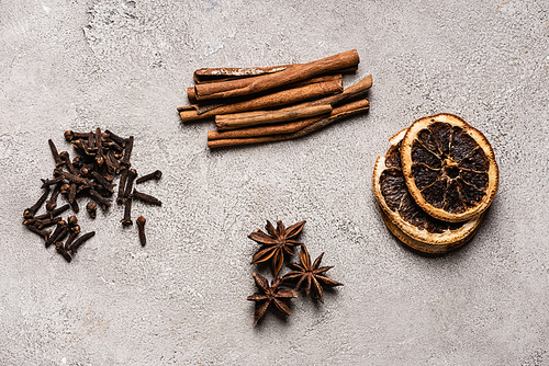 Flat lay with spices on textured and grey background