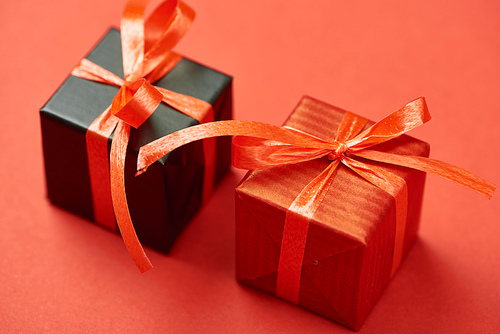 gift boxes with ribbons and bows on red background