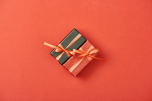 flat lay with gift boxes and shopping bags on red background