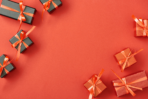 top view of small gift boxes on red background with copy space