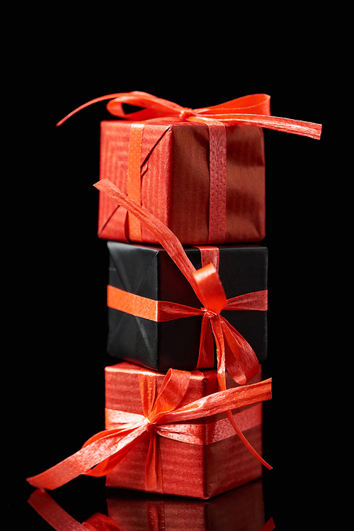 black and red decorative gifts isolated on black