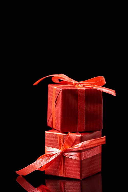 red decorative gifts isolated on black with copy space