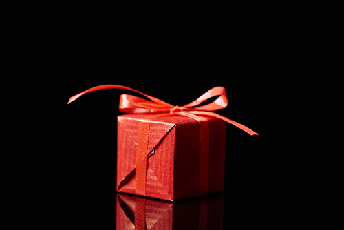 red decorative gift isolated on black with copy space