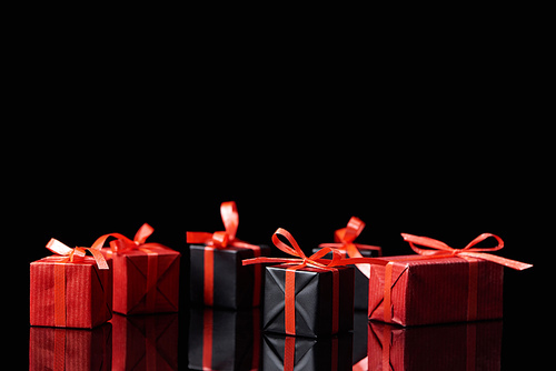 black and red decorative gifts isolated on black with copy space