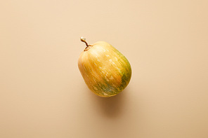 top view of ripe whole pumpkin on beige background