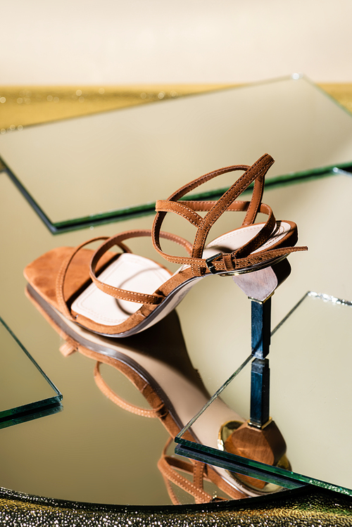 brown suede elegant heeled sandals on mirror surface