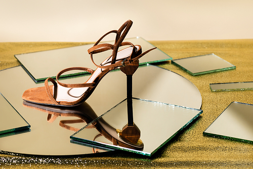 brown suede elegant heeled sandals on mirror surface