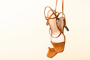 brown suede heeled sandals isolated on beige