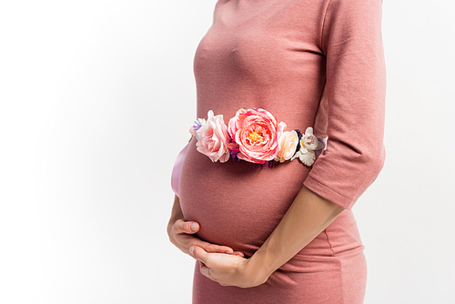 cropped view of pregnant woman with floral belt standing isolated on white