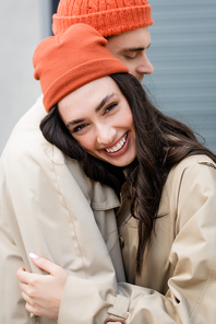 selective focus of brunette woman leaning on stylish man and 