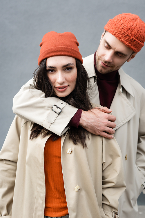 selective focus of trendy man looking at stylish woman in hat