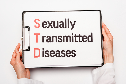 cropped view of doctor holding clipboard with sexually transmitted diseases lettering isolated on white