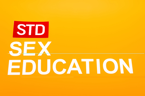 top view of sex education and std lettering isolated on orange