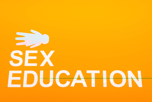 top view of sex education lettering near paper people isolated on orange with copy space