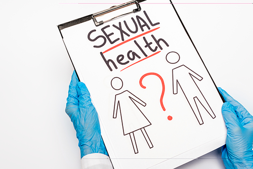 cropped view of doctor in blue latex gloves holding clipboard with sexual health lettering, drawn man and woman isolated on white
