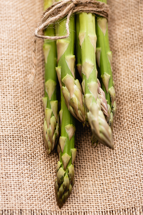 bundle of fresh green asparagus on burlap