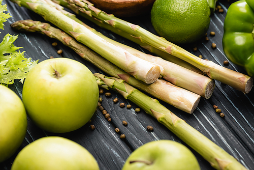fresh green ripe apples and asparagus on wooden surface
