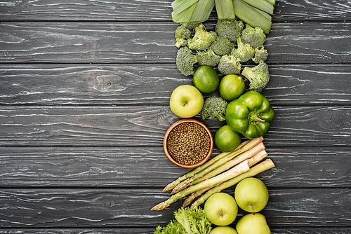top view of fresh green fruits and vegetables on wooden surface